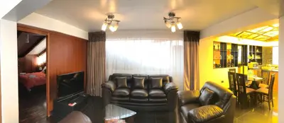 a living room with two leather chairs and a television at Del Niño Apartment, Best location in Cusco