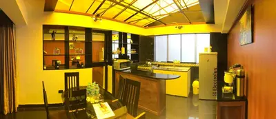 a large kitchen with yellow walls and a table at Del Niño Apartment, Best location in Cusco
