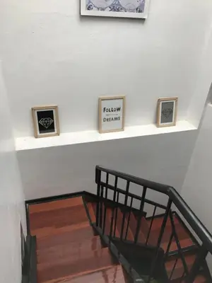 a stairway with three framed pictures on a wall at Del Niño Apartment, Best location in Cusco