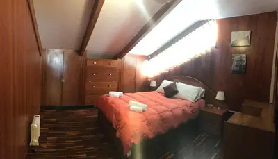 a bedroom with a bed with an orange blanket at Del Niño Apartment, Best location in Cusco