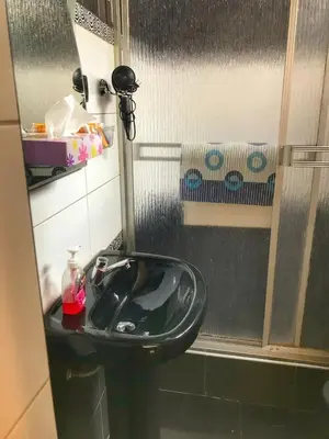 a bathroom with a black sink and a shower at Del Niño Apartment, Best location in Cusco