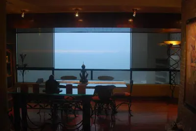 a large screen in a room with a table and chairs at Black Shark Apartments in Lima