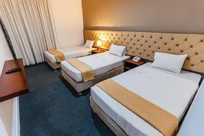 a hotel room with two twin beds at Hotel Hacienda Lima Norte in Lima