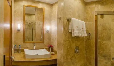 a bathroom with a sink and a shower at Taypikala Deluxe Valle Sagrado in Urubamba