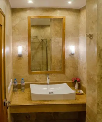a bathroom with a white sink and a mirror at Taypikala Deluxe Valle Sagrado in Urubamba