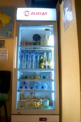 an open refrigerator filled with lots of drinks at Passion Hostel - Barranco in Lima