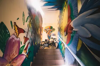 a hallway with a mural on the wall at Passion Hostel - Barranco in Lima