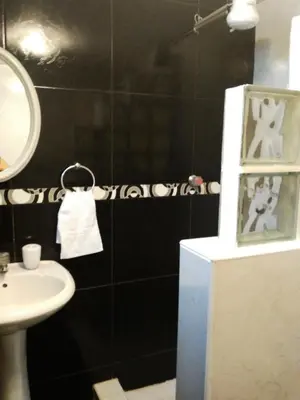 a bathroom with a sink and a mirror at White Hope Apartment in Lima