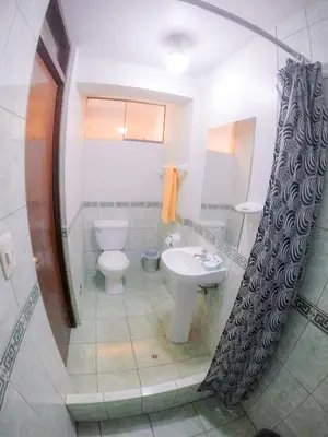 a bathroom with a toilet and a sink at Machu Picchu Land in Machu Picchu
