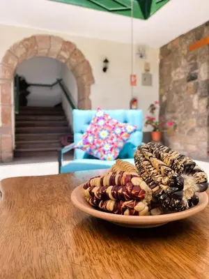 a plate of cookies on top of a wooden table at Usgar San Pedro Boutique in Cusco