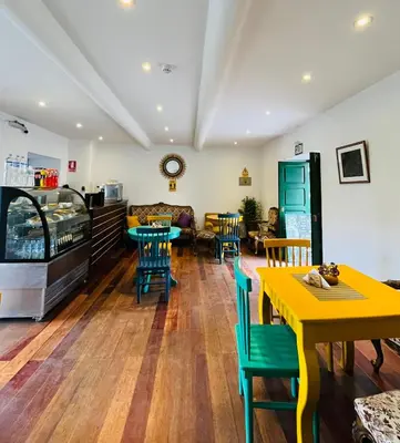 a restaurant with tables and chairs and a couch at Usgar San Pedro Boutique in Cusco