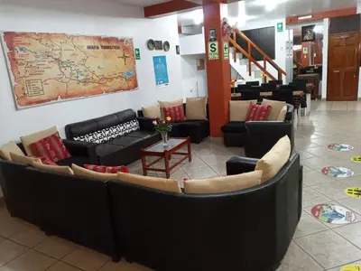 a waiting room with couches and a map on the wall at Inkas Land in Machu Picchu