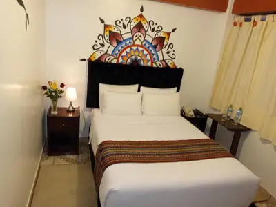 a bedroom with a bed with a painting on the wall at Inkas Land in Machu Picchu