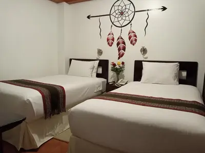 two beds sitting next to each other in a room at Inkas Land in Machu Picchu