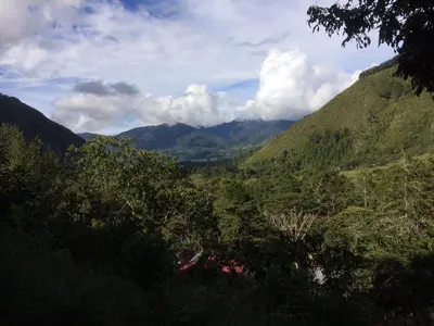 a view of a valley with mountains and trees at Illariy Tampu Ecoalbergue Oxapampa in Oxapampa