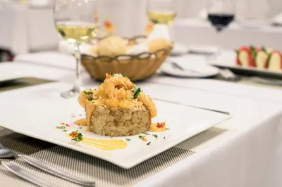 a white plate with a piece of food on a table at Inkari Suites Hotel in Lima
