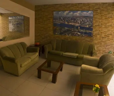 a living room with two couches and a coffee table at Montreal Hostal in Lima