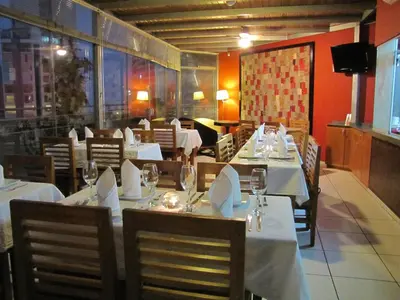 a restaurant with tables and chairs with white table cloth at Hotel Boutique Runcu Miraflores in Lima
