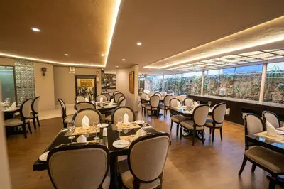 a restaurant with tables and chairs and a large window at Jose Antonio Executive in Lima