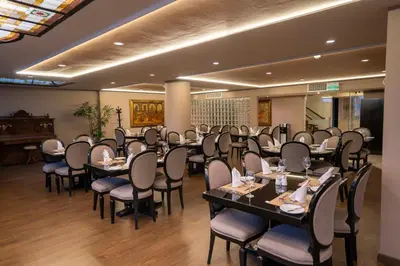 a conference room with tables and chairs and a piano at Jose Antonio Executive in Lima