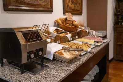 a counter with a toaster oven and bread on it at Hotel Jose Antonio Cusco in Cusco