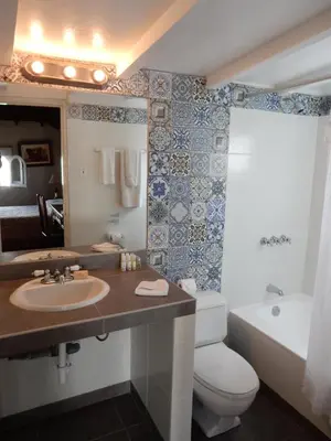 a bathroom with a sink and a toilet and a tub at Hotel Antigua Miraflores in Lima