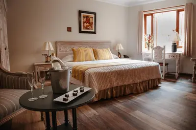 a bedroom with a bed and a table with cupcakes on it at Hotel Antigua Miraflores in Lima