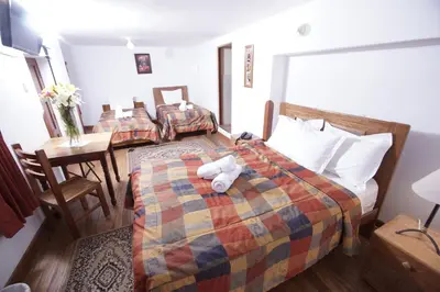 a hotel room with a bed with a stuffed animal on it at Casa Union Cusco in Cusco