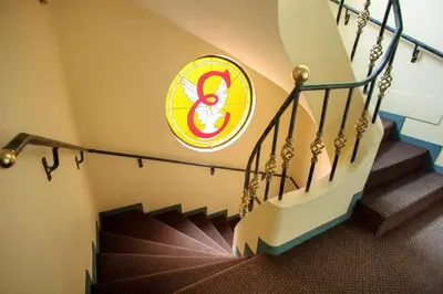 a spiral staircase with a sign on the wall at Embajadores Hotel in Lima