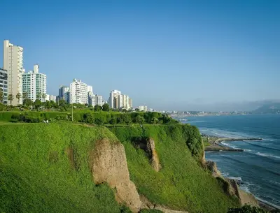 a view of the ocean with buildings in the background at Embajadores Hotel in Lima