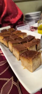 a plate with several pieces of bread on a table at Faraona Grand Hotel in Lima