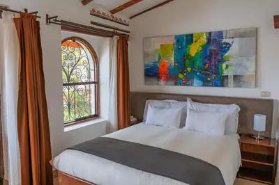a bedroom with a bed and a window at Hotel Encantada Casa Boutique Spa in Cusco