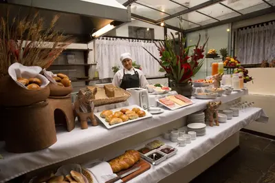a chef standing in front of a buffet of food at Hotel Encantada Casa Boutique Spa in Cusco