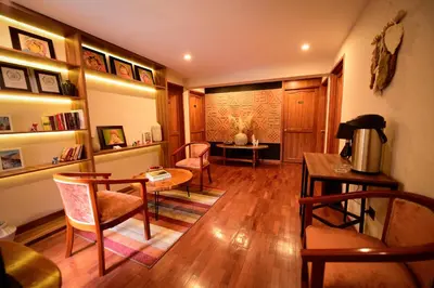 a living room with a table and chairs at Torre Dorada Cusco in Cusco