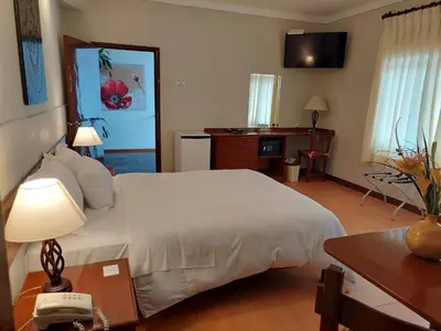 a bedroom with a bed and a desk and a phone at Lima Wasi Hotel Miraflores in Lima