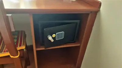 a wooden desk with a safe on a shelf at Lima Wasi Hotel Miraflores in Lima