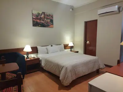 a hotel room with a bed and a desk and a chair at Lima Wasi Hotel Miraflores in Lima