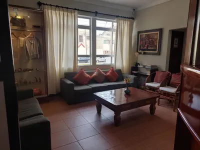 a living room with a couch and a coffee table at Lima Wasi Hotel Miraflores in Lima