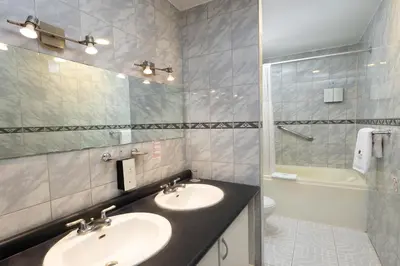 a bathroom with a sink and a shower and a toilet at Hotel Hacienda Cusco Plaza in Cusco