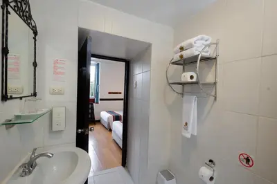 a bathroom with a sink and a toilet and a mirror at Hotel Hacienda Cusco Plaza in Cusco
