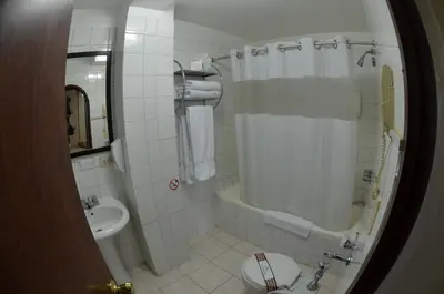a bathroom with a tub and a sink and a toilet at Nodo Cusco Santa Teresa in Cusco