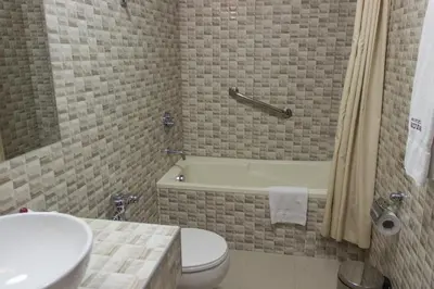 a bathroom with a toilet and a sink and a tub at Hotel Ruinas in Cusco