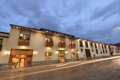 a building with lights on the side of a street at Hotel Ruinas in Cusco