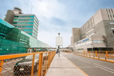 a person walking on a bridge in front of buildings at Wyndham Costa del Sol Lima Airport in Lima