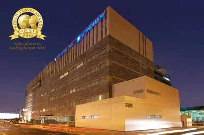 a building with a sign on the side of it at Wyndham Costa del Sol Lima Airport in Lima