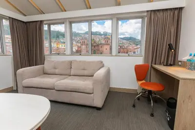a living room with a couch and a table at Casa Andina Standard Cusco Plaza in Cusco
