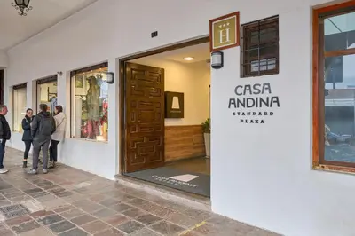 a group of people standing outside of a store door at Casa Andina Standard Cusco Plaza in Cusco