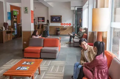 a group of people sitting in a lobby at Casa Andina Standard Cusco Catedral in Cusco