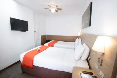 a hotel room with a bed and a flat screen tv at Casa Andina Standard Cusco Catedral in Cusco