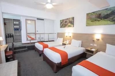 a hotel room with two beds and a window at Casa Andina Standard Cusco Catedral in Cusco
